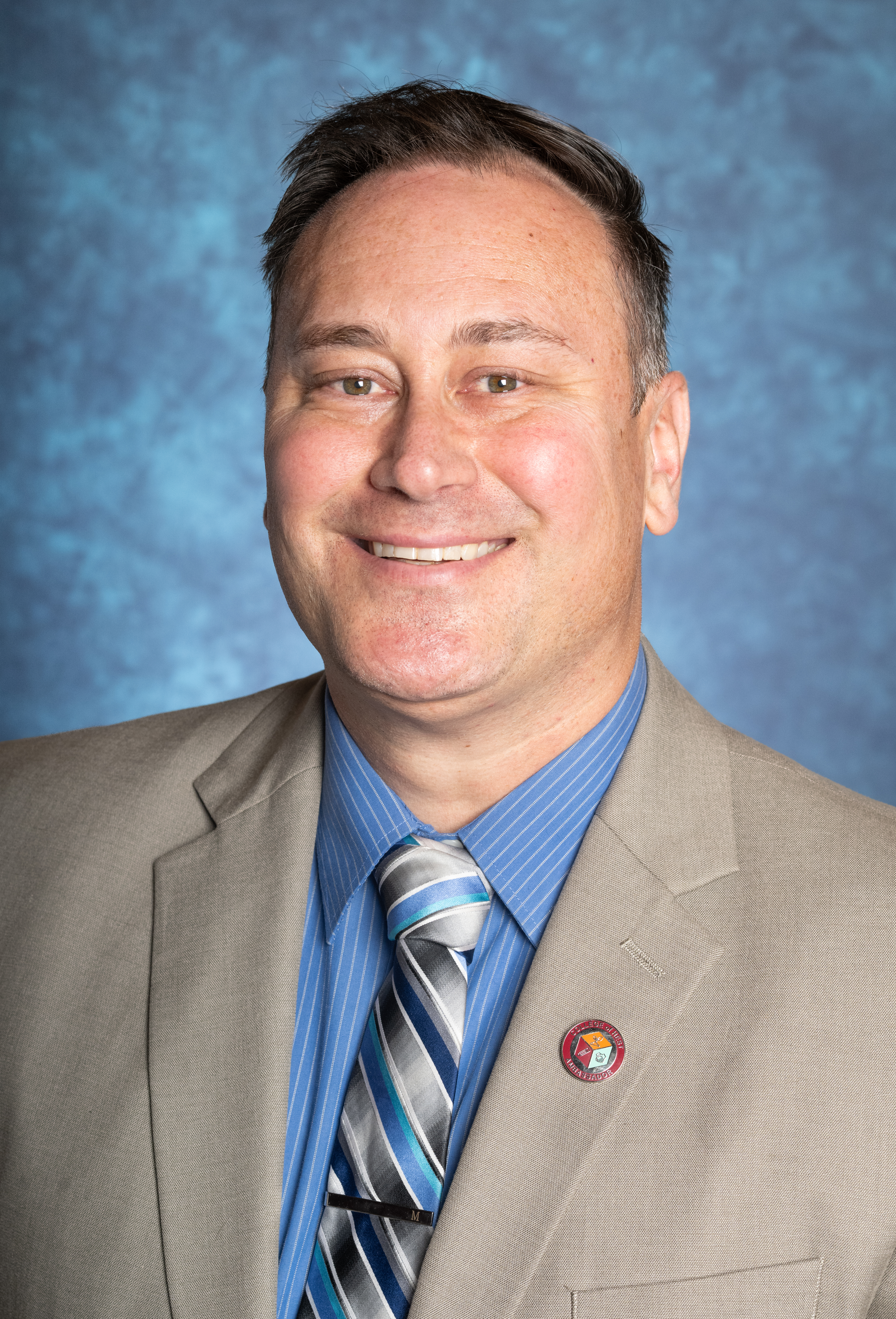Man with suit smiling for photo